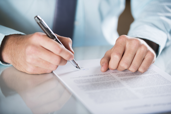 Businessman is signing a contract, business contract details